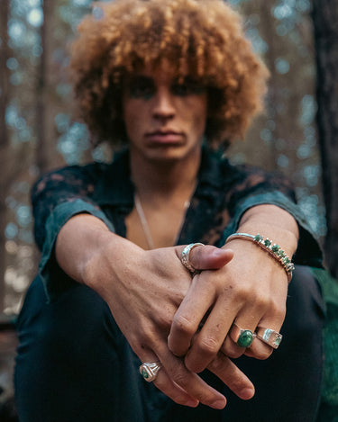 Handsome style with emerald and silver rings and cuffs from the Regal Rebel collection by RAFU APPU.